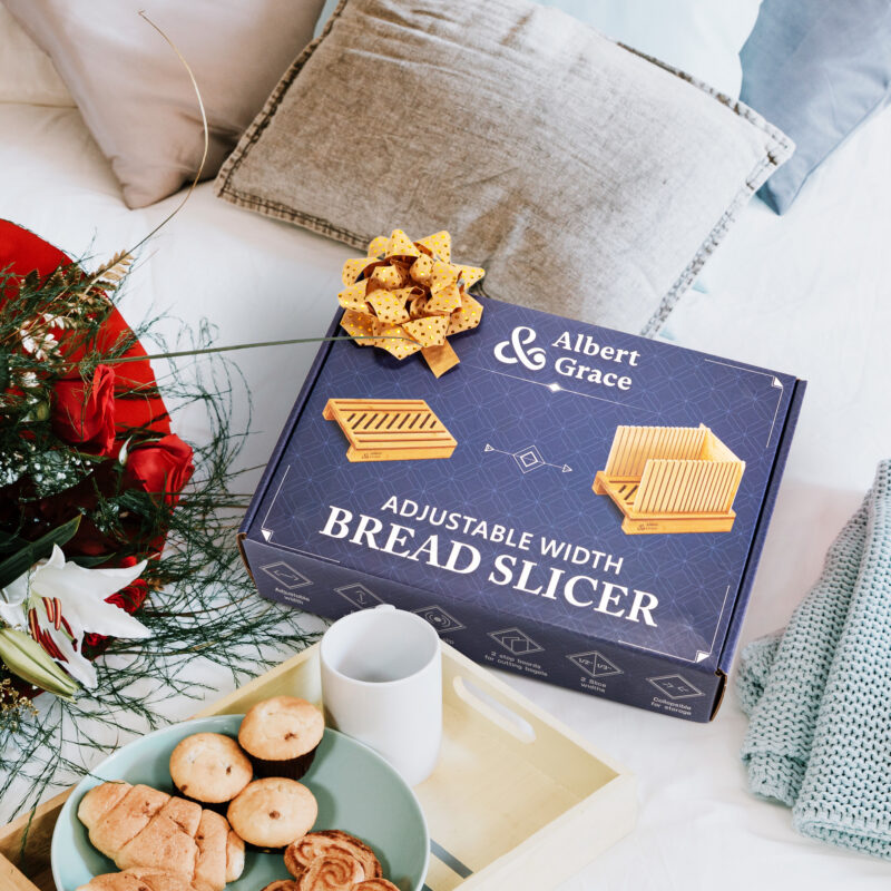Bread slicer in a gift package on table with flowers